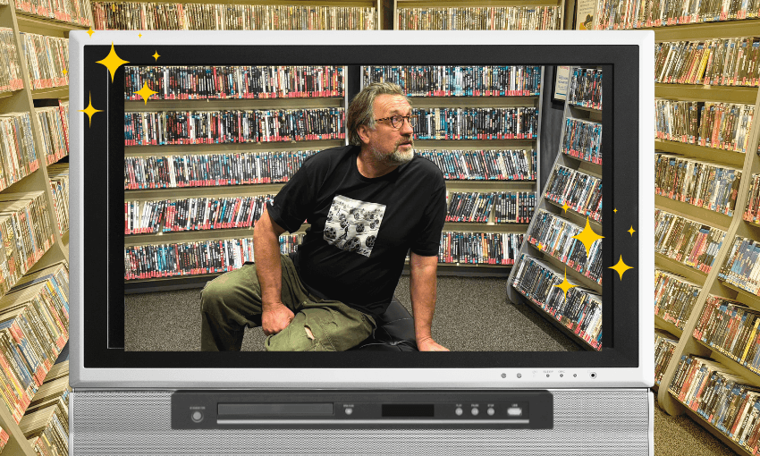 A television screen with a DVD player showing a man sitting in a room full of DVDs