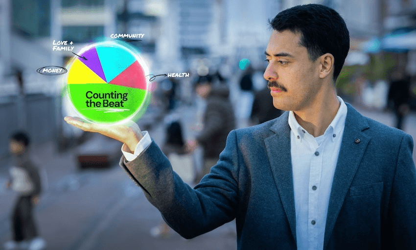 Tāmati Rimene-Sproat stands in a busy city looking at a graphic on his hands