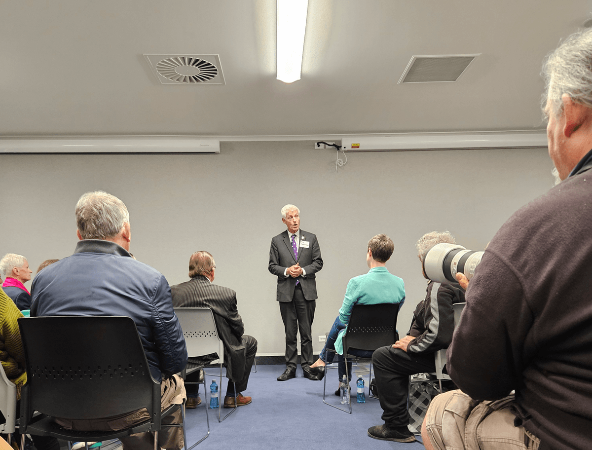 Tim Macindoe talking to a crowd of people at a mayoral debate