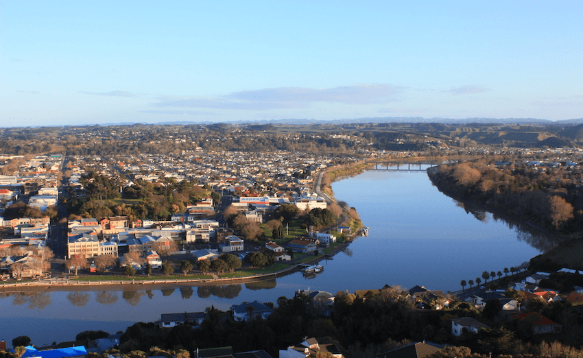 An aerial shot of the Whanganui river and township against clear blue skies