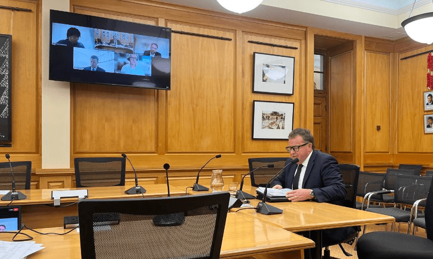 Inside select committee room 4, where privacy commissioner Michael Webster sits at the head of a long table speaking to MPs.