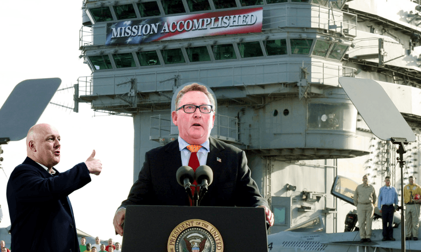 a man in a suit photoshopped over where George W. Bush stood in front of a ship with a "mission accomplished" sign draped over it. Chris Luxon in a suit gives a thumbs up off to the side
