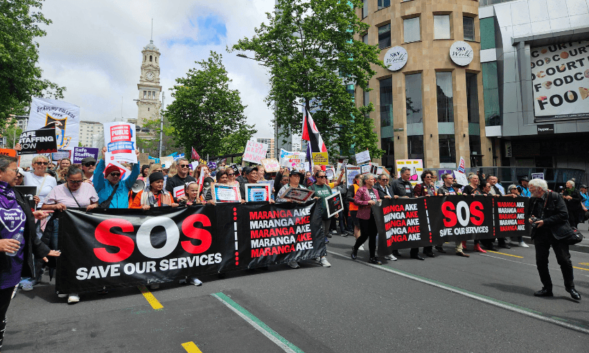 Striking workers walk down Queen Street in Auckland (Photo: Hayden Donnell) 
