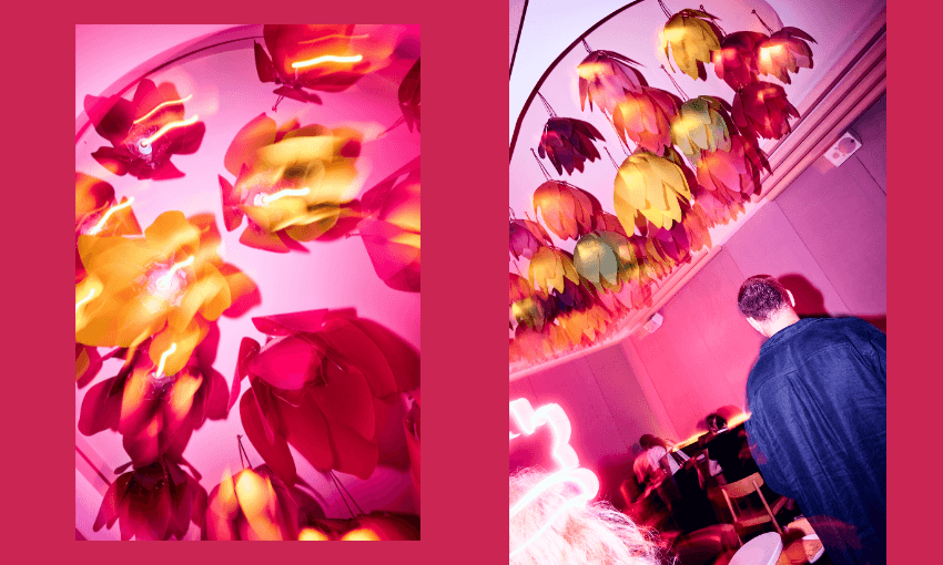 Two vibrant photos: the left shows a close-up of colorful, flower-shaped lights in pink and yellow hues; the right shows people sitting under the same lights in a modern room, with one person in a dark jacket in the foreground.