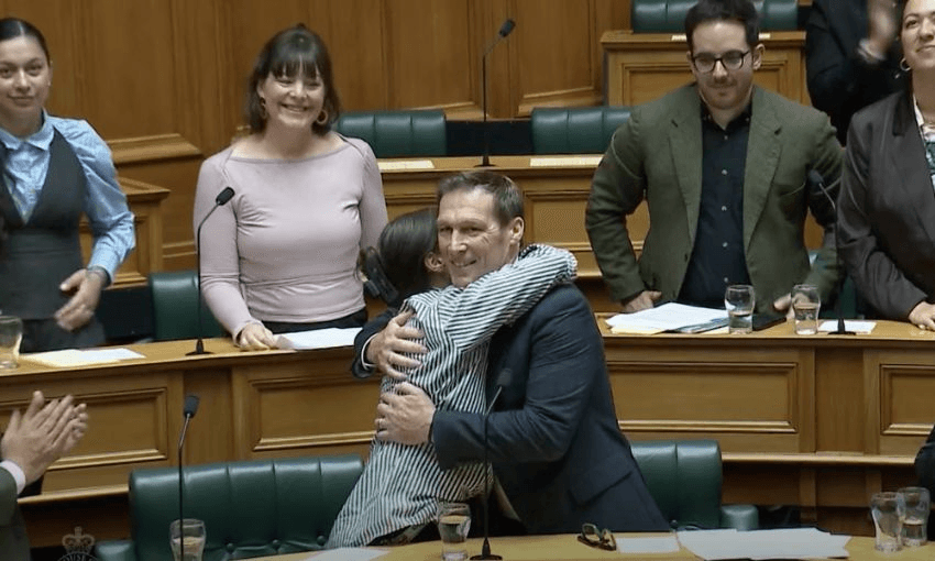 Chloe Swarbrick embraces Mike Davidson in the House after giving his maiden speech.
