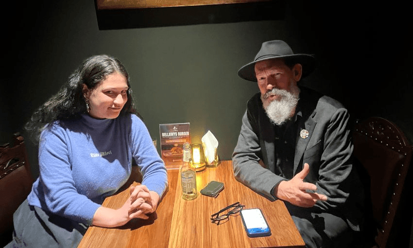 MP Steve Abel and journalist Lyric Waiwiri-Smith sit together at a table, looking at the camera.
