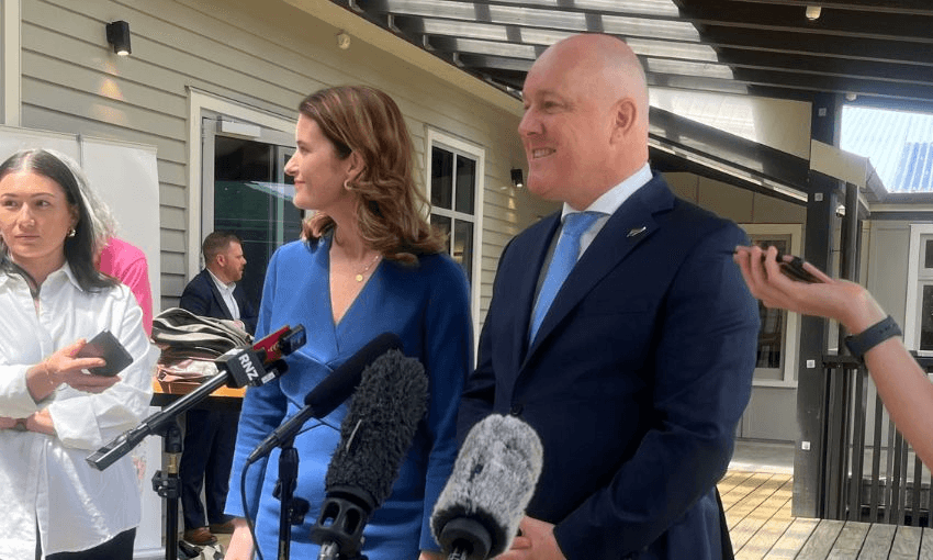 Nicola Willis and Christopher Luxon stand together at an outdoor press conference.