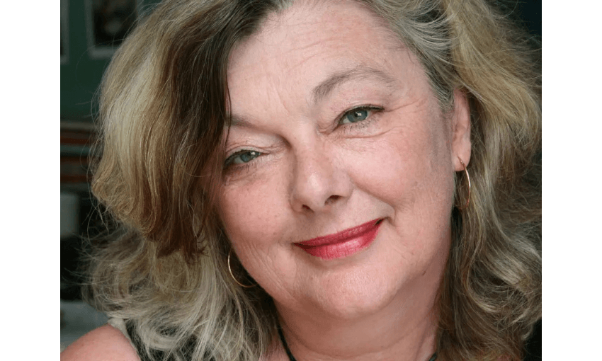 A close up of a face of a woman who is smiling. 