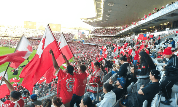 An excited Tongan crowd celebrating the second tackle of a set.  
