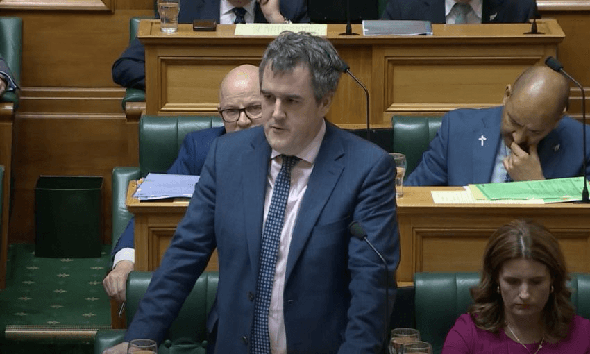 Chris Bishop stands at his bench to speak in the House.