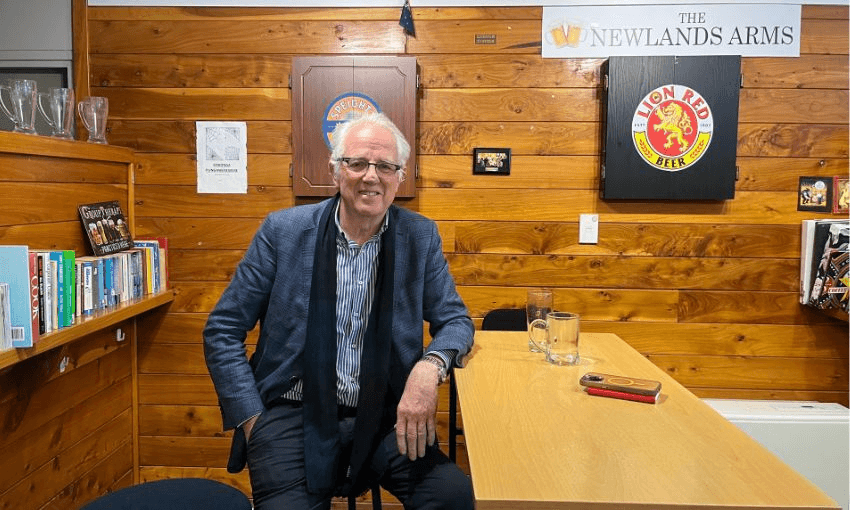Greg O'Connor sits in the "cobweb's corner" of the Newlands Arms, smiling.