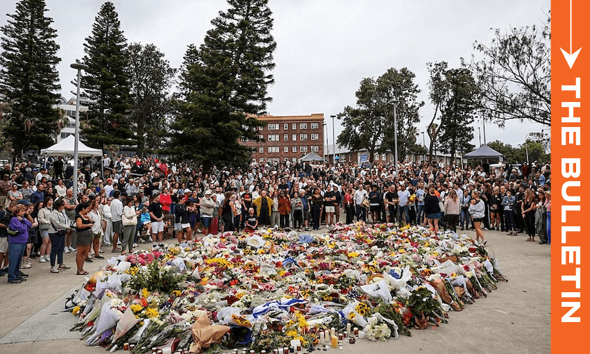 Mourners gather to lay flowers at Bondi Beach. (Photo: Izhar Khan/Getty Images) 
