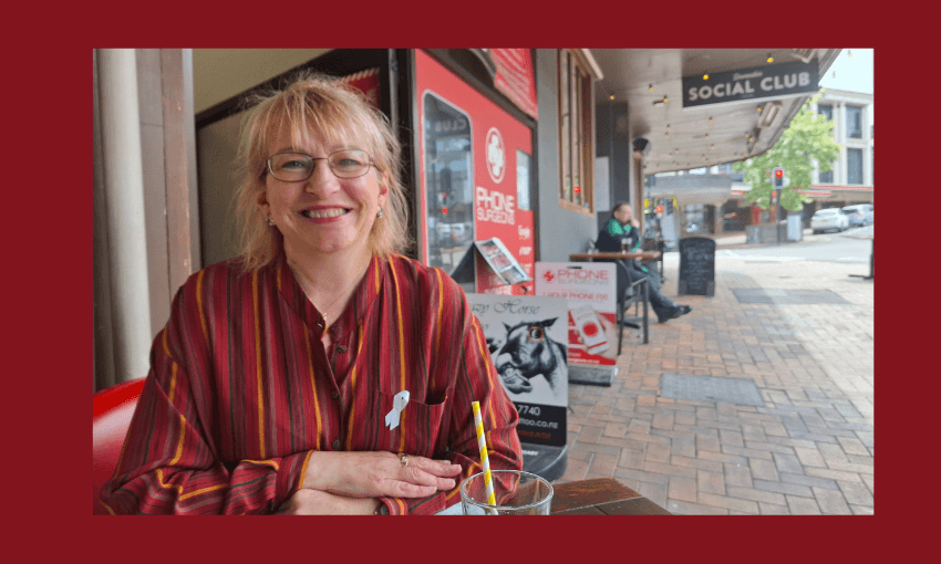 Sophie Barker sits at a table in the Octagon in Dunedin