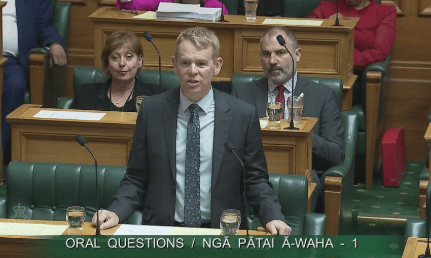 Chris Hipkins stand and speaks at his bench in the House.