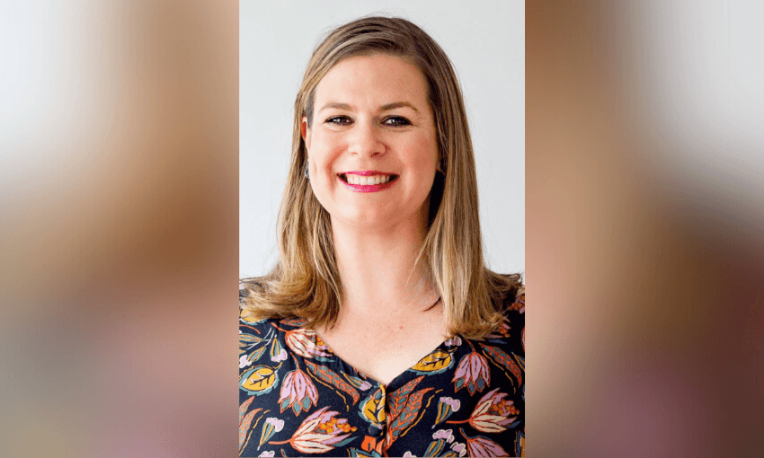 a white woman with blonede hair and pink lipstick smiling at the camera