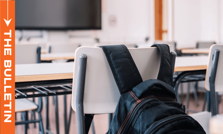 A black backpack hangs on the back of a classroom chair. Empty desks and chairs fill the room. An orange vertical banner on the left reads "The Bulletin.