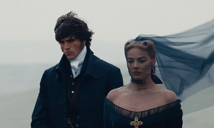 Jacob Elordi and Margot Robbie in Wuthering Heights. They are dressed in black and look sad.