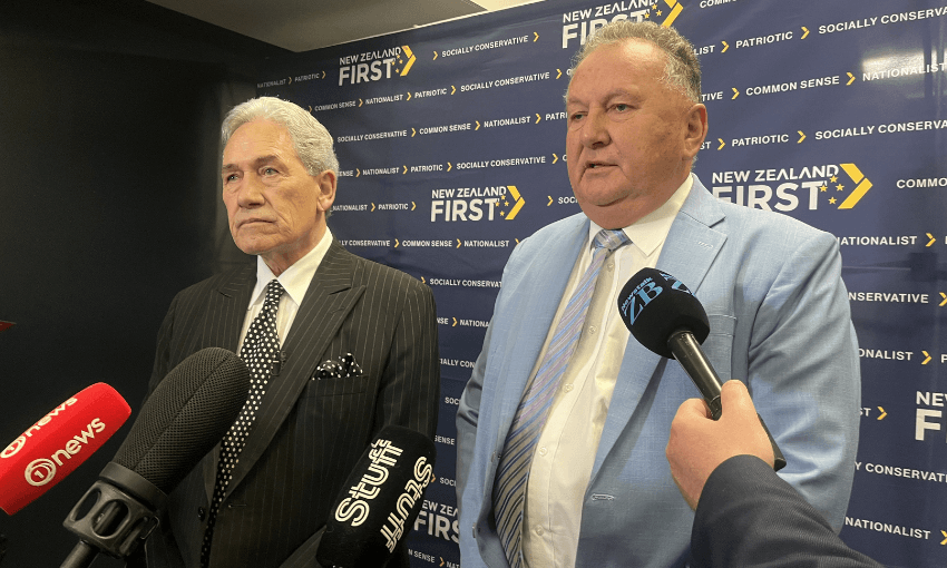 Winston Peters and Shane Jones speak to media in front of a NZ First banner.