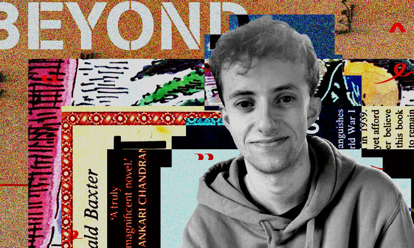 A black and white photo of a young man wearing a hoody and smiling.