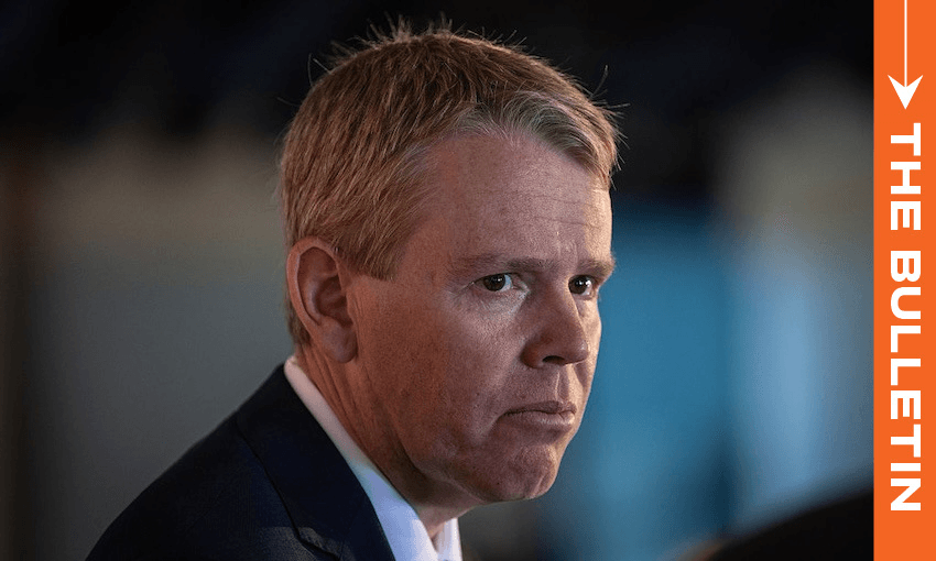 A man in a suit looks serious while facing left; the background is blurred. An orange vertical banner on the right reads "THE BULLETIN" in white text.