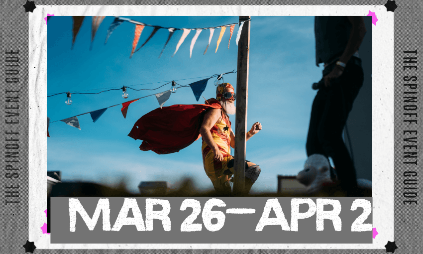 A man on a unicycle wearing wings and a helmet is against a blue sky. There is bunting in the fore and backgrounds.