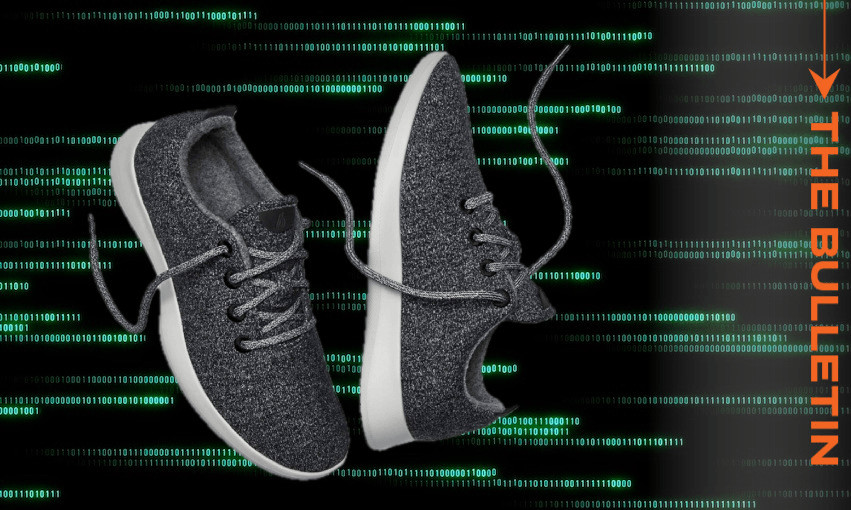 A pair of gray sneakers floats over a background of green binary code, with the words "THE BULLETIN" in orange on the right side.