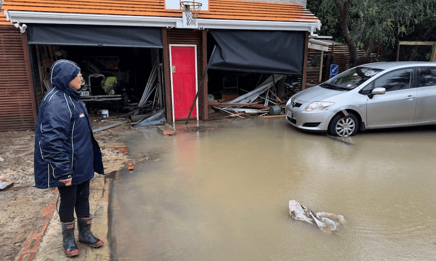 A resident on Wellington’s Balfour St looks at the damage on Monday.  (Photo: SAMUEL RILLSTONE / RNZ) 
