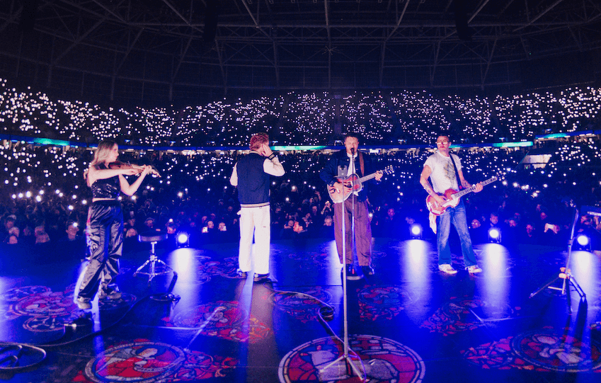 Six60 and Sythony violinists onstage at One NZ Stadium. Image: Supplied 
