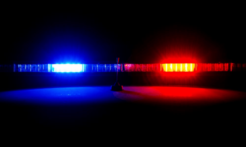 a single blue and red police light on a stark black background