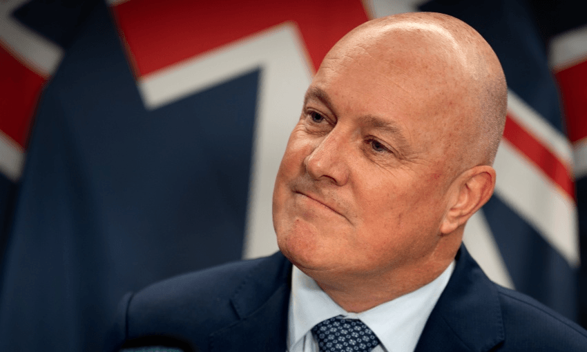 Luxon at the lectern in April. (Photo: Annaleise Shortland/New Zealand Herald via Getty Images)