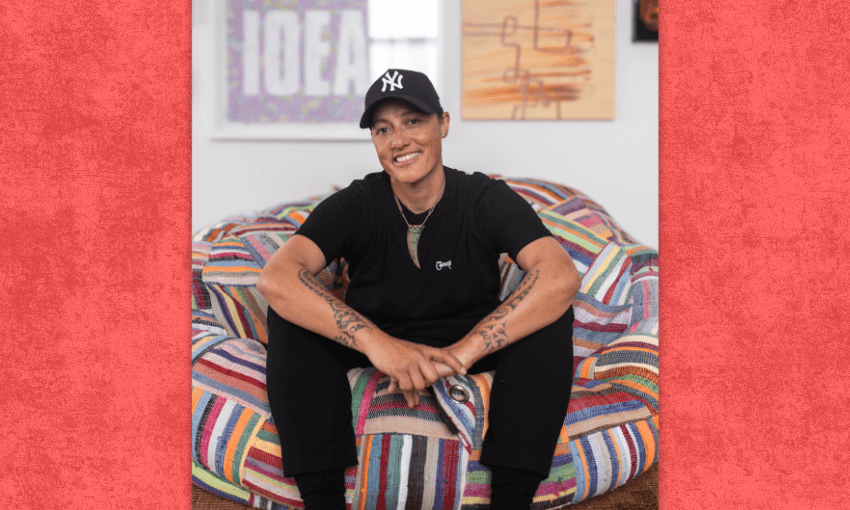 Kiri Allan sitting on a chair looking relaxed and smiling.