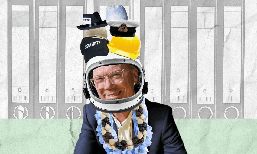 A smiling person in a suit wears an astronaut helmet, many hats stacked on top, and a flower lei, with a background of filing cabinets.