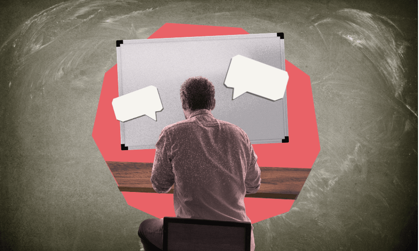 A man sits at a desk with his back to the camera. There are two speech bubbles above him and a whiteboard against a stylised blackboard background featuring a red hexagon shape.