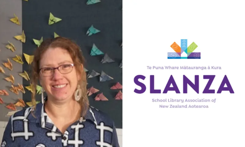 a portrait of a woman with red hair and glasses, smiling at the camera. on the right, the logo for SLANZA