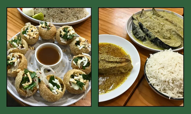 A plate of pani puri with sauce, and plates of fish and eggplant curry and rice are displayed on a wooden table, separated by a green border.