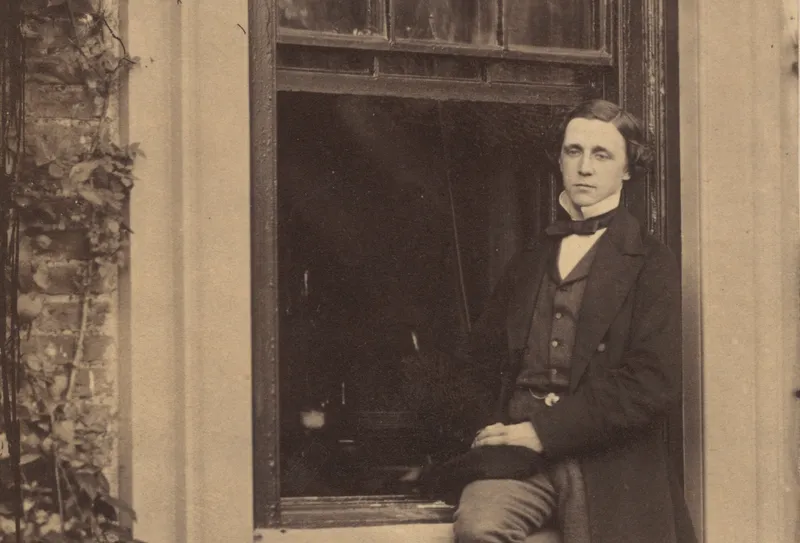 Lewis Carroll seated on a windowsill