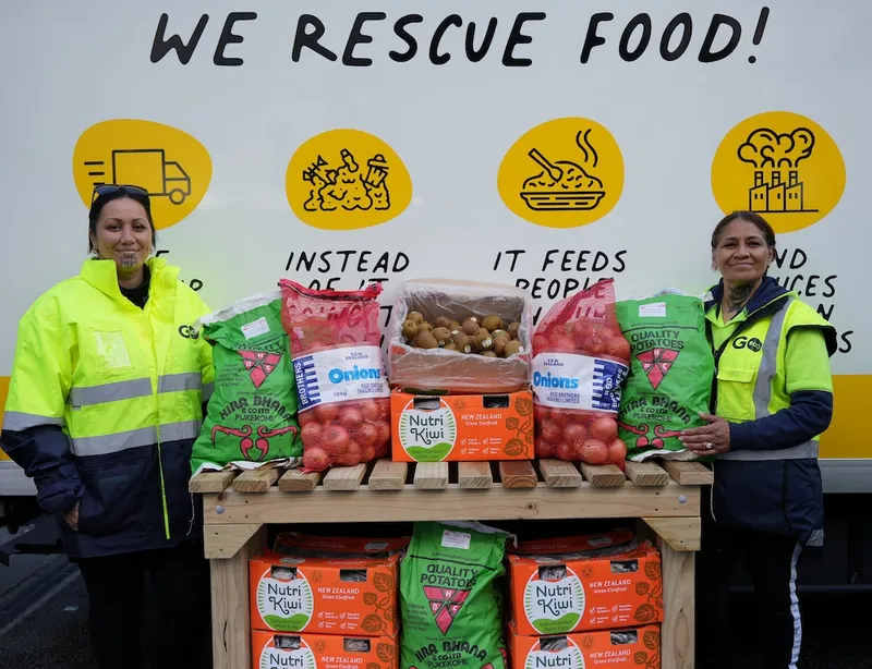 two smiling women iwth moko kauae and big packets of food saying 'we rescue food'