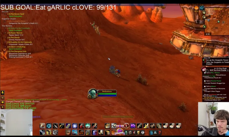 a red screen of a fantasy game with colourful icons of tools at the bottom of the frame and a brow haired slightly wide eyed white man in the corner of the screen