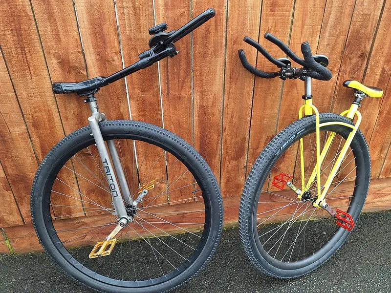 Left: Ken Looi's unicycle for the world record attempt. A grey unicyle with a long handlebar. Right: The V-frame unicycle that Guinness wouldn't allow. The frame is yellow.