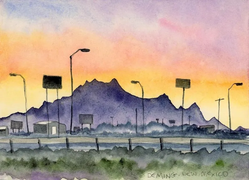 Watercolour painting of a skyline featuring silhouetted lamp posts and billboards against a sunset in Deming, New Mexico. Distant purple mountains contrast with a colorful sky of pink, orange, and yellow hues.