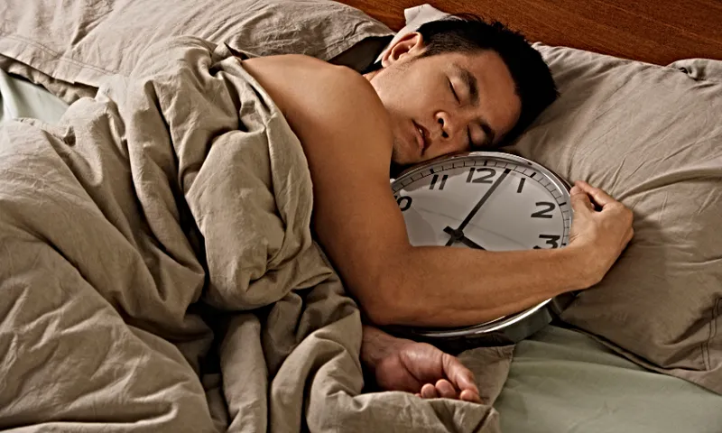 A man lies in bed gripping a clock