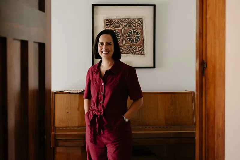 woman in red jumpsuit standing in hallway