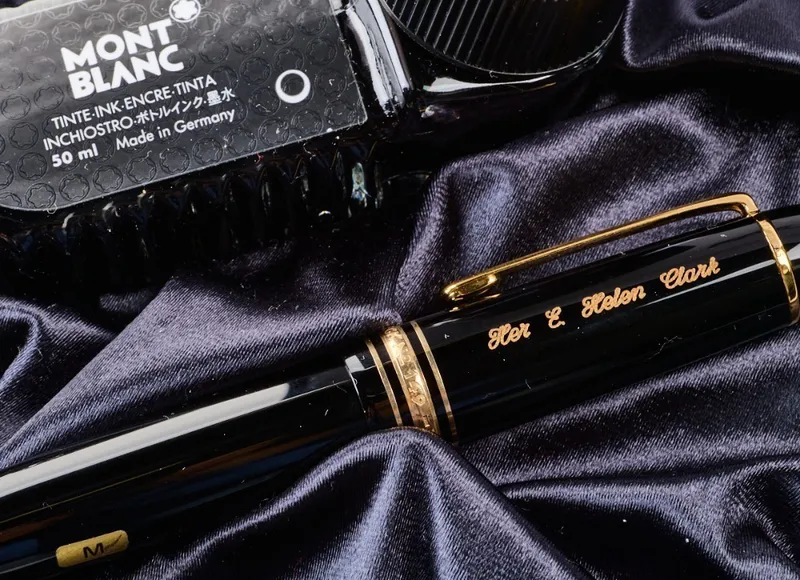 photo of a black pen with gold details