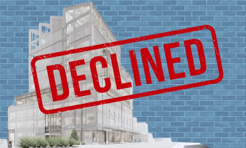 A modern building design with a large red "DECLINED" stamp over it, set against a blue brick wall background.