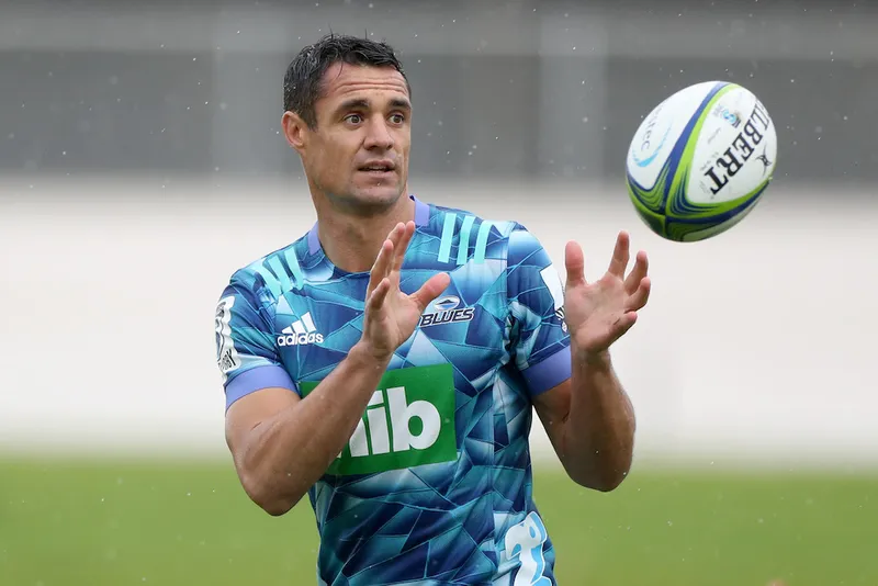 dan carter catching a rugby ball wearing a blues jersey