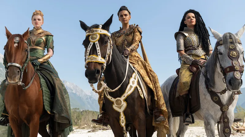 Three women dressed in armour sit on horses