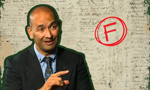 A man in a suit gestures while speaking, set against a background of handwritten notes. A red letter "F" is superimposed on the image.