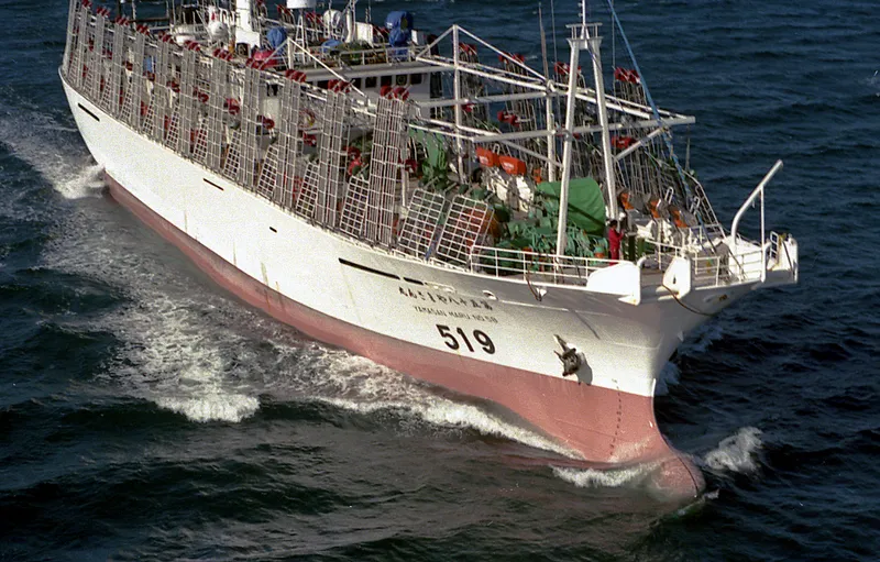 a big steel boat with lots of fishing gear on it
