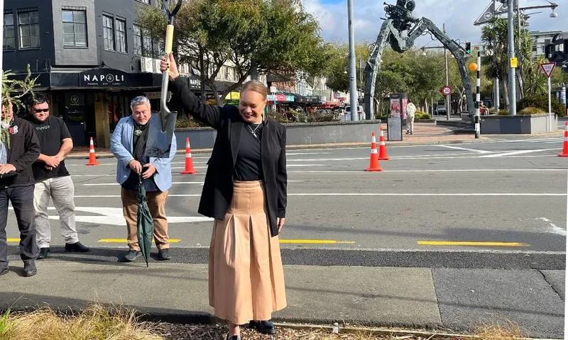 Mayor Tory Whanau stands at a traffic island on Cambridge Terrace with a shovel in hand.