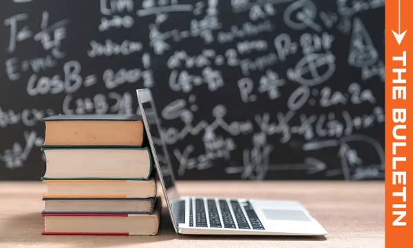 A stack of books and an open laptop sit on a desk in front of a chalkboard filled with math equations. An orange vertical banner on the right reads "THE BULLETIN.